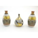 Three Japanese vases, comprising a pair decorated with a landscape scene with quail birds and