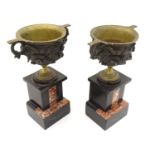 A pair of cast garnitures modelled as pedestal cup urns on slate and marble bases. Approx. 9 3/4"