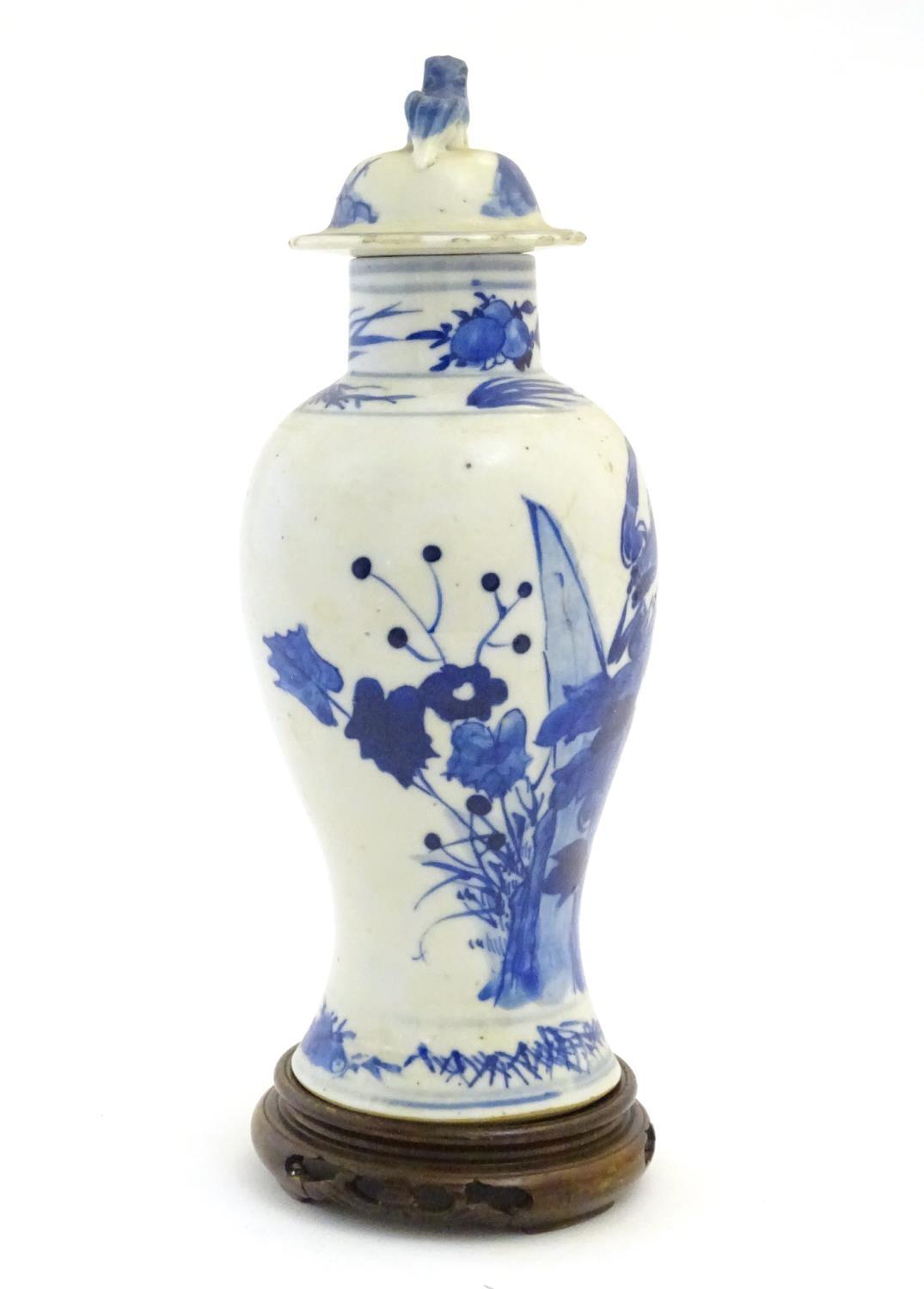 A Chinese blue and white vase and cover with floral, foliate and bird detail. The lid with foo dog - Image 5 of 7