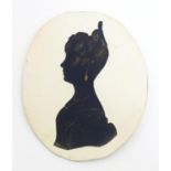 A 19thC oval silhouette portrait miniature depicting a woman in profile, with gilt highlights.