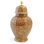 An Oriental vase and cover of octagonal baluster vase with floral and foliate gilt detail. Marked