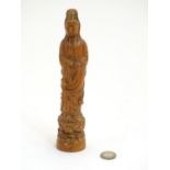 A Chinese carved figure modelled as the bodhisattva Quan Yin on a lotus flower base. Approx. 8 1/