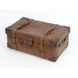 An early 20thC leather trunk with carrying handles to the sides and leather straps. 30" long x 18"