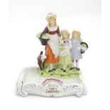 A Yardley English Lavender advertising figural group depicting a woman, two children and a dog.