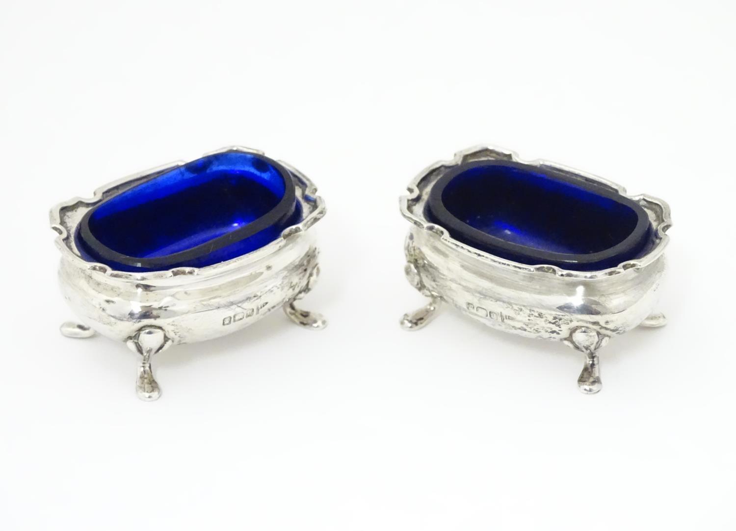 A pair of silver salts with blue glass liners, hallmarked Sheffield 1908 maker Walker & Hall. 2 1/2"