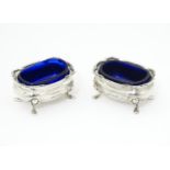 A pair of silver salts with blue glass liners, hallmarked Sheffield 1908 maker Walker & Hall. 2 1/2"