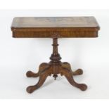 A late 19thC walnut card table with a rectangular top above Greek key decoration and a turned