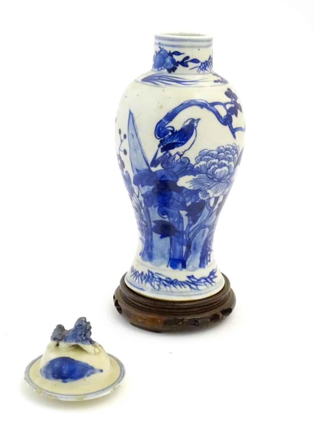 A Chinese blue and white vase and cover with floral, foliate and bird detail. The lid with foo dog - Image 6 of 7