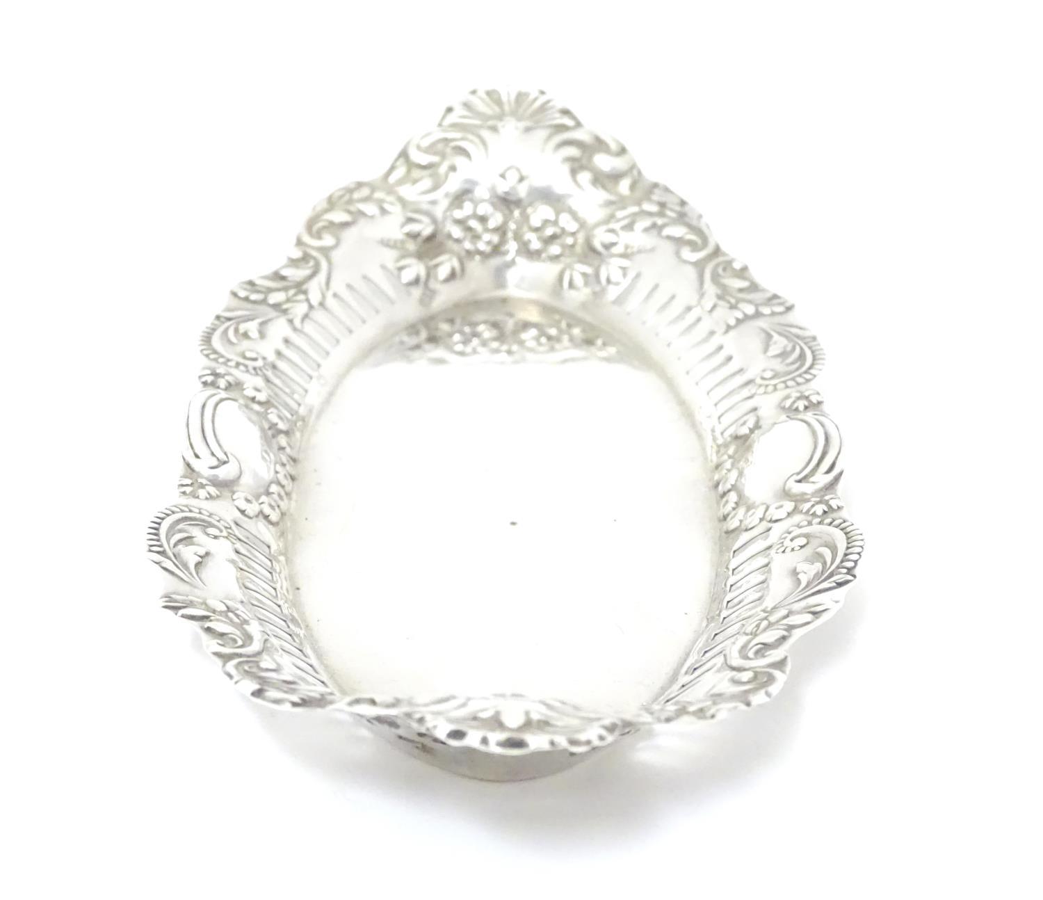 A silver dish of oval form with pierced and embossed decoration , hallmarked Birmingham 1899 maker - Image 5 of 6