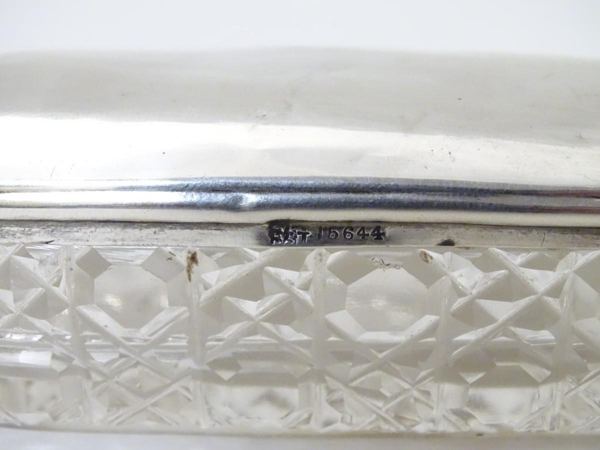 A cut glass dressing table pot with silver top hallmarked Chester 1907 maker Synyer & Beddoes. 3/4'' - Image 5 of 6