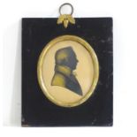 A 19thC oval silhouette portrait miniature depicting a gentleman in a jacket and tie / cravat,