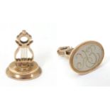 A gold pendant fob seal formed a lyre, 1" high. Please Note - we do not make reference to the