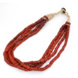A vintage retro coral like bead necklace, the four strands of cylindrical formed beads with Indian