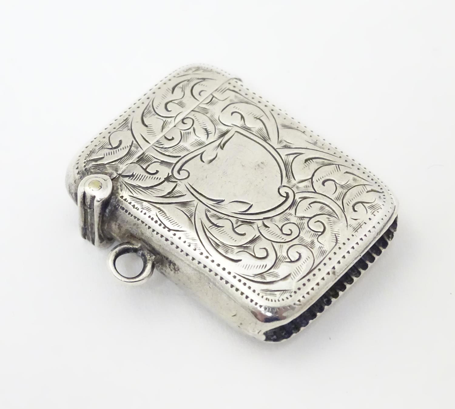 A silver vesta case with engraved decoration. Hallmarked Birmingham 1913 maker Joseph Gloster Ltd. 1