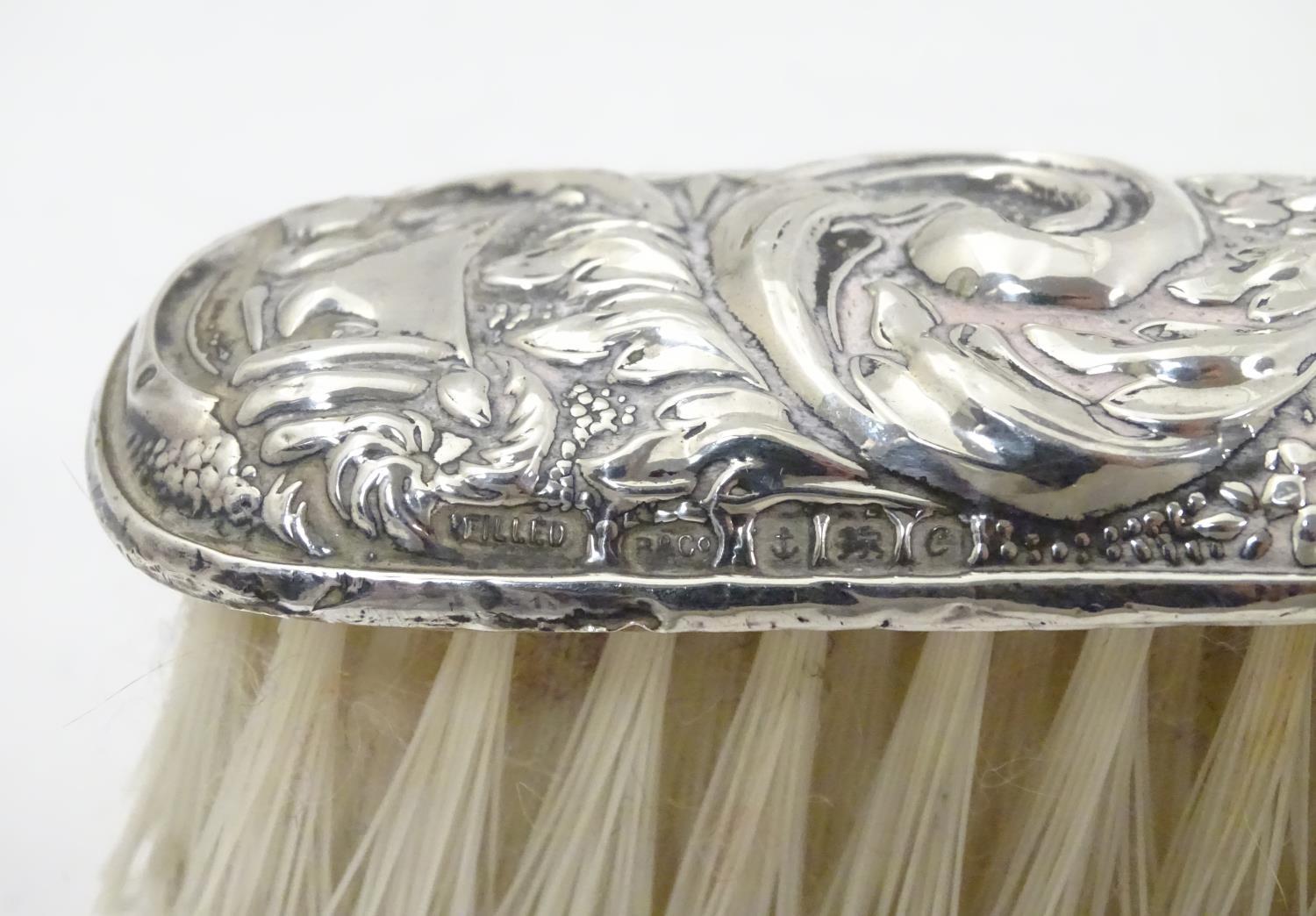 A silver handled brush together with a silver backed brush both with embossed decoration. Hallmarked - Image 4 of 5