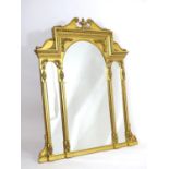 A mid 20thC giltwood mirror with a rosette carved swans neck pediment and an urn to the centre.