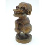 Ethnographic / Native / Tribal: A carved wooden native figure on a circular base. Approx. 8 1/2"