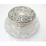 A cut glass powder jar with embossed silver lid, hallmarked Birmingham 1976 maker W I Broadway &