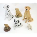 Three assorted ceramic models of dogs to include a large Golden Labrador and two Dalmations.