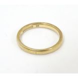 A 9ct gold ring of band form ( approx 2.1g) Ring size approx L 1/2 Please Note - we do not make