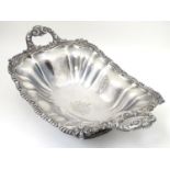 A 19thC silver plate pedestal dish with twin handles and engraved coat of arms to centre with