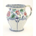 A Maling jug of baluster form with floral and foliate detail. Marked under. Approx. 7 1/4" high