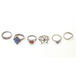 Six assorted silver and white metal rings with various decoration including one set with goldstone