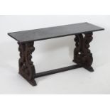 A marble top table with two carved and scrolled supports united by a rectangular stretcher. 48 "