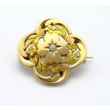 A 9ct gold brooch set with central seed pearl 1'' diameter Please Note - we do not make reference to