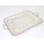 A large silver plate two handled tray with engraved decoration 26" wide overall. Please Note - we do
