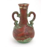 A late 19th / early 20thC bottle vase with shaped twin handles, and dragon decoration. Approx. 9"