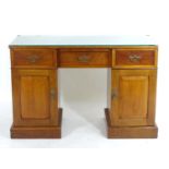 An early 20thC mahogany double pedestal desk with a rectangular top above three short drawers with