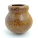 A 20thC Welsh burr elm turned vase with a bulbous body by Paul Clare. Signed under. Approx. 9 1/4"