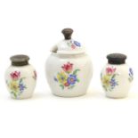 A German three piece ceramic cruet set with floral decoration, the white metal tops marked 835.