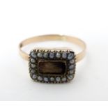 Memorial / Mourning jewellery : A 19thC 9ct gold ring with central plaited lock of hair bordered