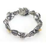 A German .800 silver bracelet with oak leaf and acorn detail set with deer's tooth detail. Please