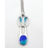 A silver and enamel pedant in the Art Nouveau style 1 1/4" long with a silver chain 18" long