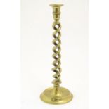 A Victorian brass candlestick with an open twist column. Approx. 13 3/4" Please Note - we do not