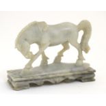 An Oriental soapstone carving modelled as a horse on a rectangular base. Approx. 5" high Please Note
