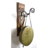 An Art Nouveau William Tonks & Sons brass wall mounting dinner gong and beater. The wall mounting