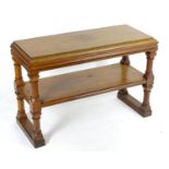 A late 19thC / early 20thC oak two tier console table with a chamfered frame, four canted