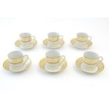 A set of six Limoges coffee cups / cans and saucer with scrolling gilt decoration. Marked under.