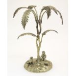 A Victorian centrepiece / epergne stand cast as a boy and a dog with a stylised palm tree. Approx.