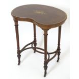An early 20thC mahogany table with a kidney shaped top having crossbanded detailing and decorative