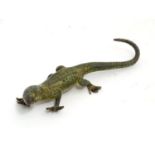 A bronze cold painted model of a lizard. Approx. 4 1/2" long Please Note - we do not make