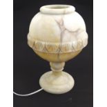 An alabaster table light with carved band detail and pedestal base. Approx 13 1/2" high Please