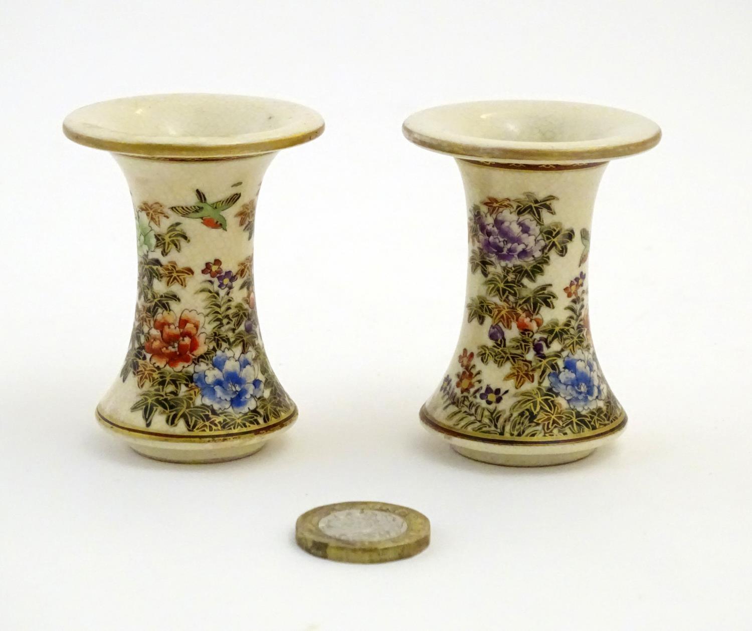 A pair of Japanese miniature Satsuma vases with flared rims and bases, decorated with flowers and - Image 2 of 8