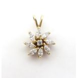 A 9ct gold pendant of flower form set with white stones. 3/4" long Please Note - we do not make