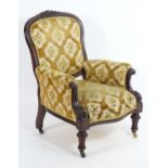 A mid / late 19thC library chair with a moulded carved cresting rail above upholstered back rest,