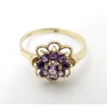 A 9ct gold ring set with amethyst cluster. The ring size approx L. Please Note - we do not make
